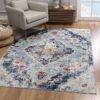 Elegant blue floral area rug in cozy living room.