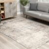 Modern living room with gray furniture and abstract rug