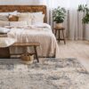 Cozy bedroom with wood bed, plants, and patterned rug.