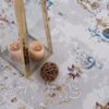 Decorative lantern and ball on ornate carpet.
