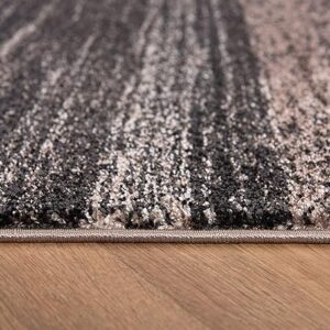 Close-up of textured gray carpet on wooden floor.