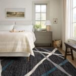 Bright bedroom with bed, nightstand, and abstract rug