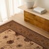 Decorative rug beside wooden table and lamp.