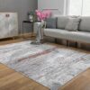 Modern living room with gray rug and sofa.