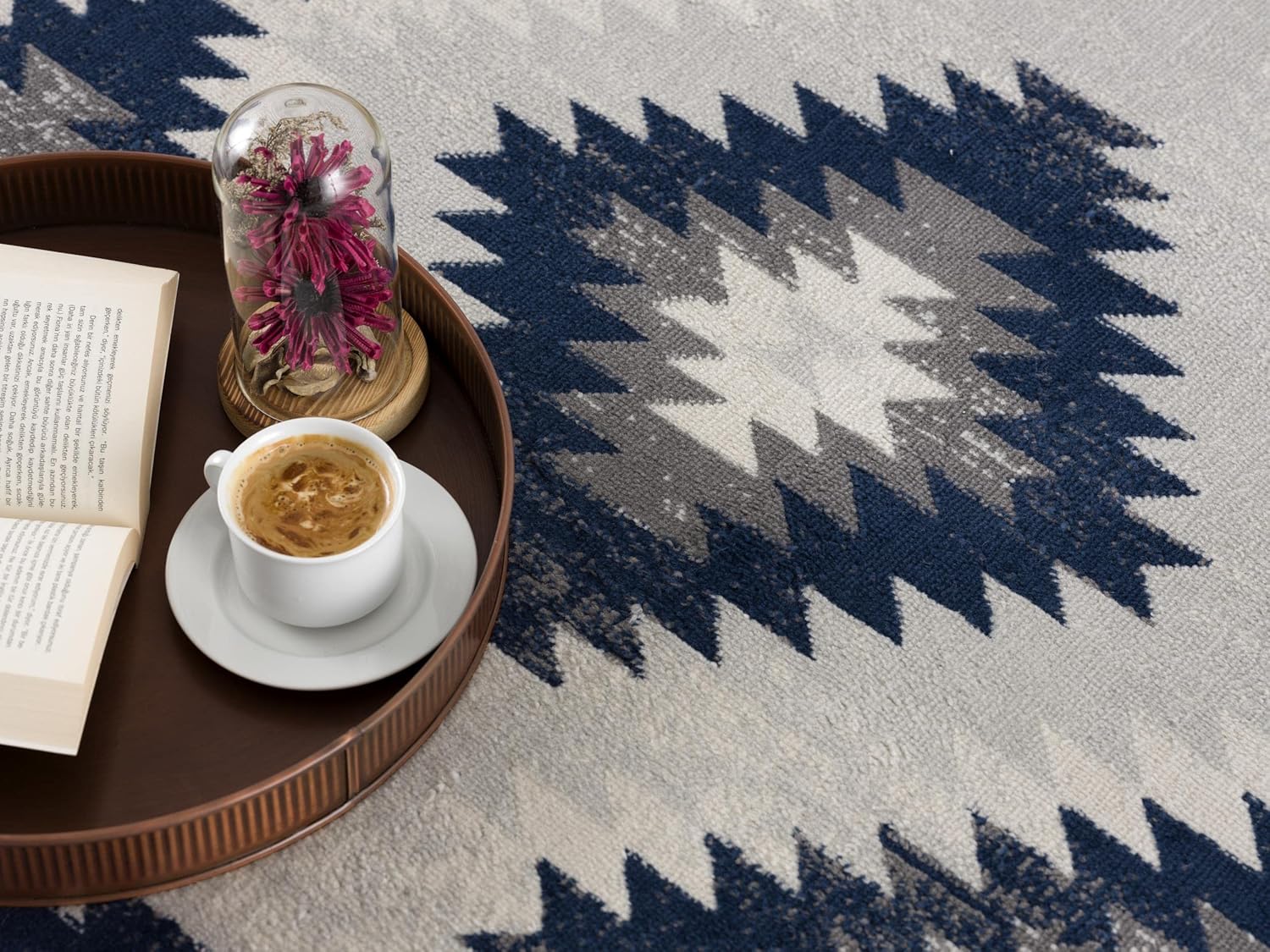 Coffee on tray with open book and flowers.