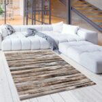 Modern living room with gray sectional and rug.