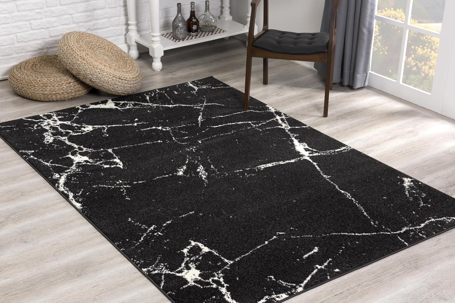 Modern black rug with white abstract pattern.