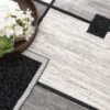 Modern geometric rug with book and flowers
