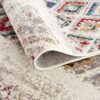 Close-up of rolled colorful patterned rug.