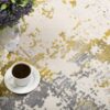 Coffee and flowers on abstract rug.