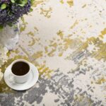 Coffee and flowers on abstract rug.