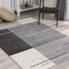 Gray geometric living room rug on wooden floor