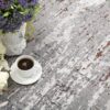 Coffee and flowers on textured gray rug