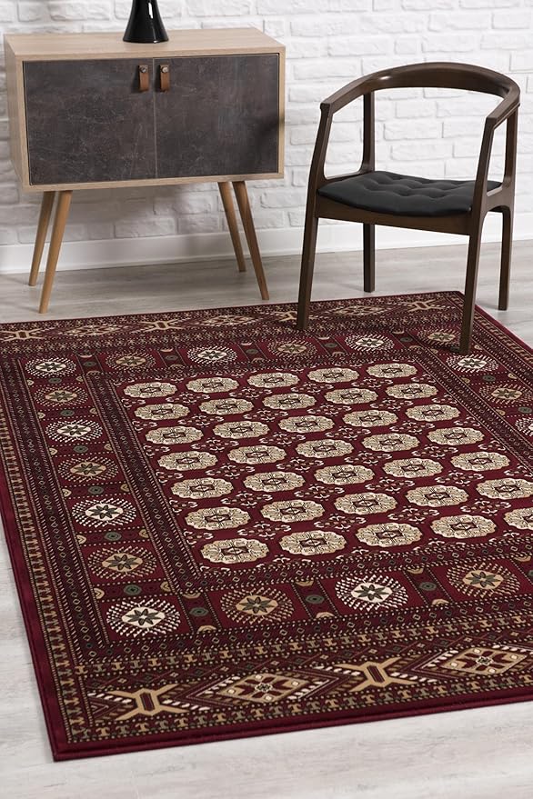 Red patterned rug, chair, and cabinet in room.