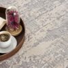 Coffee, book, flowers on round tray, textured carpet