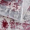 Abstract red and gray pattern area rug.