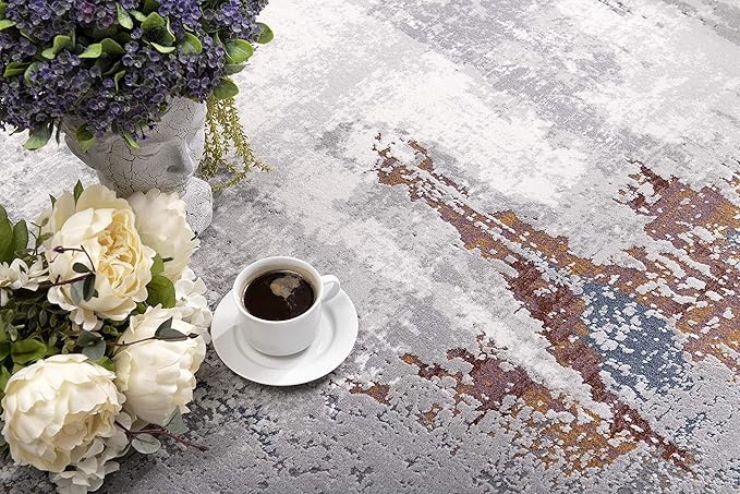 Floral arrangement with coffee on textured rug.