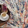 Coffee on tray with abstract colorful rug