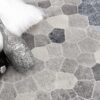 Decorative bottles on geometric patterned rug