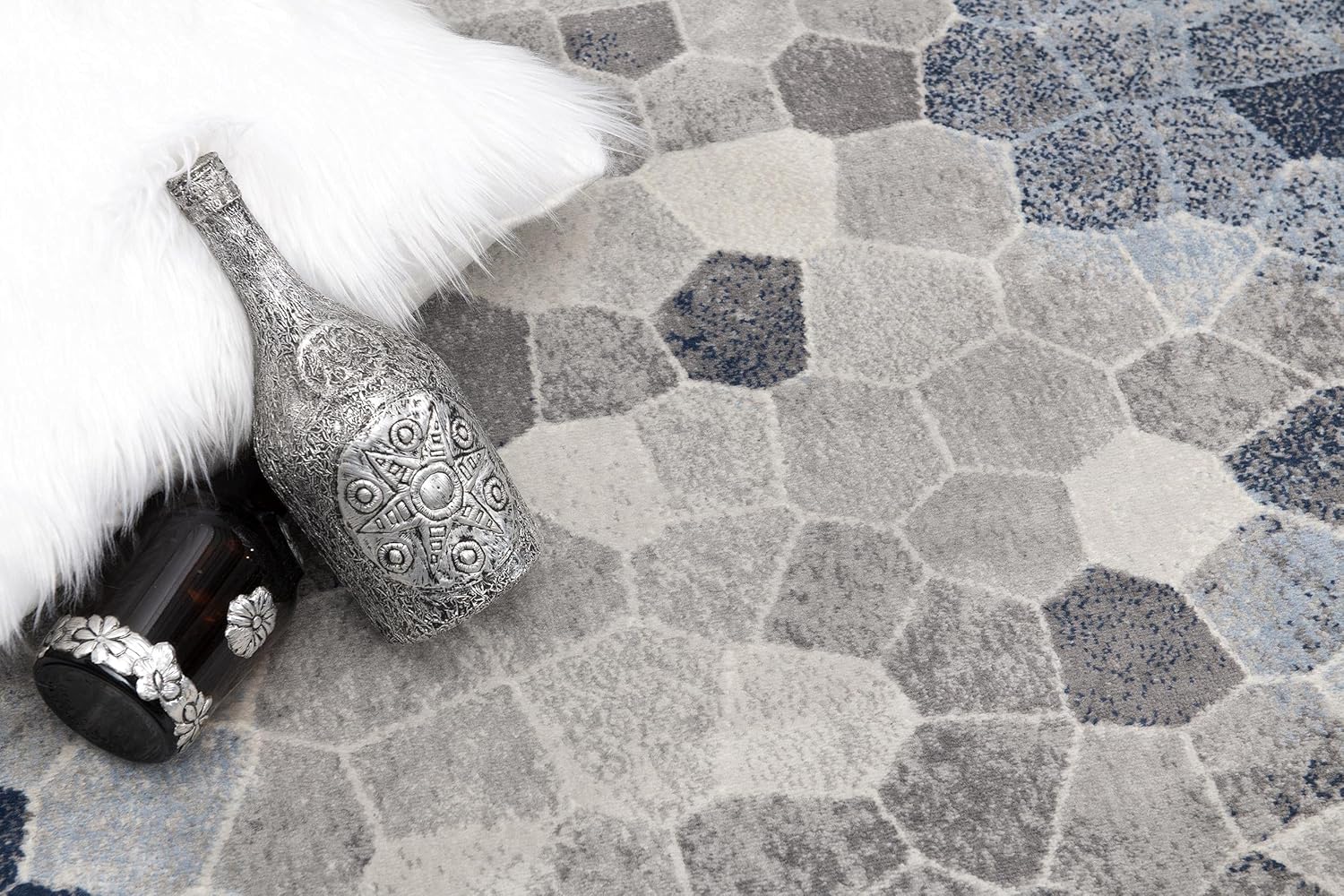 Decorative bottles on geometric patterned rug