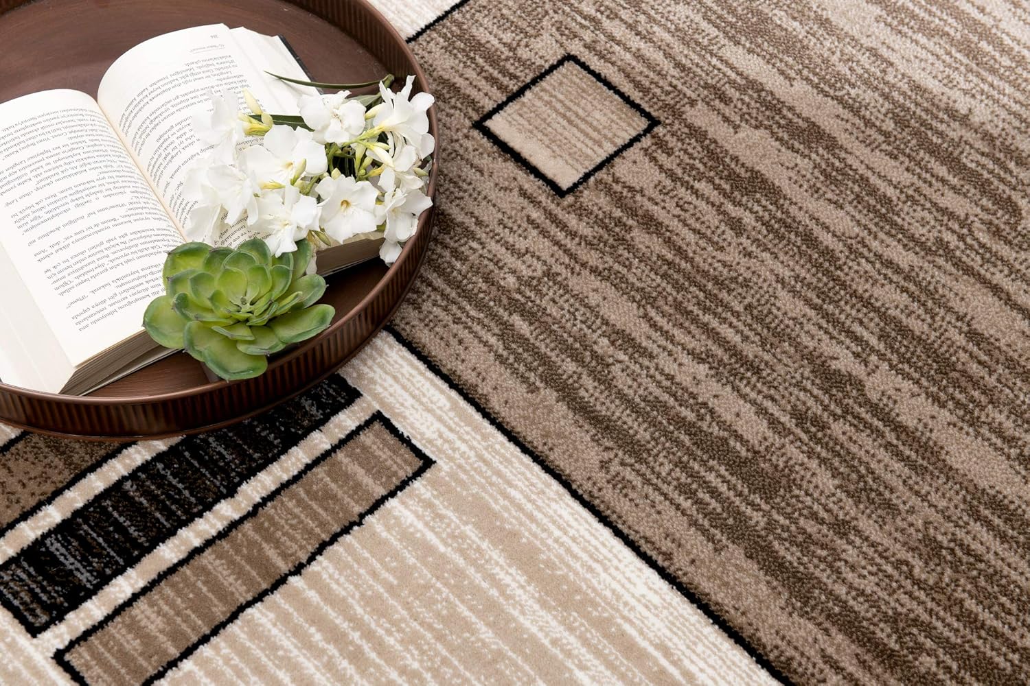 Open book with flowers on patterned carpet.