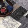 Textured rug with decorations, tea set, and book.