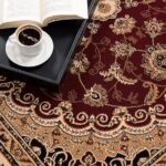 Ornate rug with coffee and open book nearby.