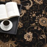 Coffee and book on floral patterned carpet