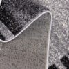 Close-up of gray textured carpet design.