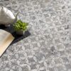 Teapot, open book, and plant on floral carpet