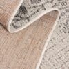 Close-up of textured beige woven rug.