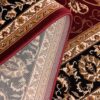 Close-up of intricate patterned rug corner.