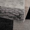 Close-up of textured gray and black rug pattern.
