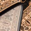 Intricate floral-patterned carpet corner close-up.