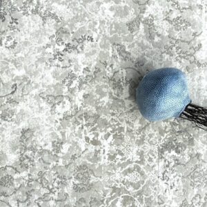 Blue textured object on patterned gray surface.