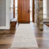 Entryway with wooden door and runner rug