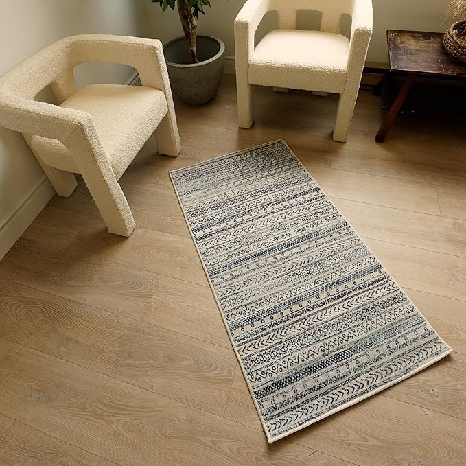 Decorative rug between two modern chairs.