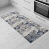Blue and gray abstract kitchen rug on floor.