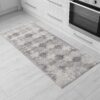 Gray patterned kitchen rug on wood floor.