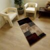 Modern chairs and geometric rug in cozy room.