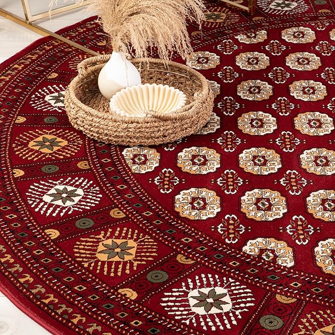 Red patterned rug with woven basket and pampas grass.