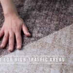 Hand touching durable carpet for high-traffic areas.