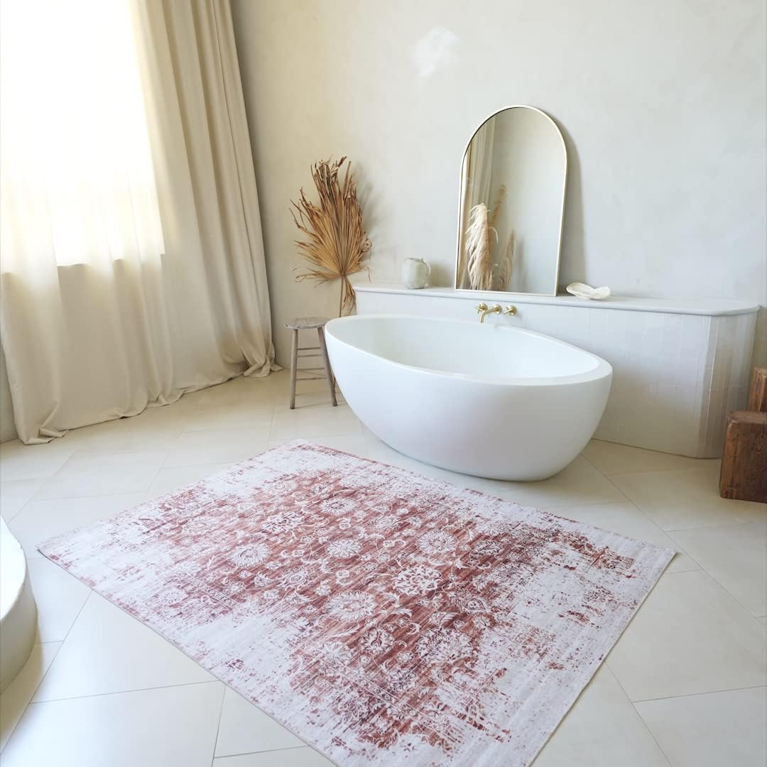 Minimalist bathroom with freestanding tub and decorative rug.