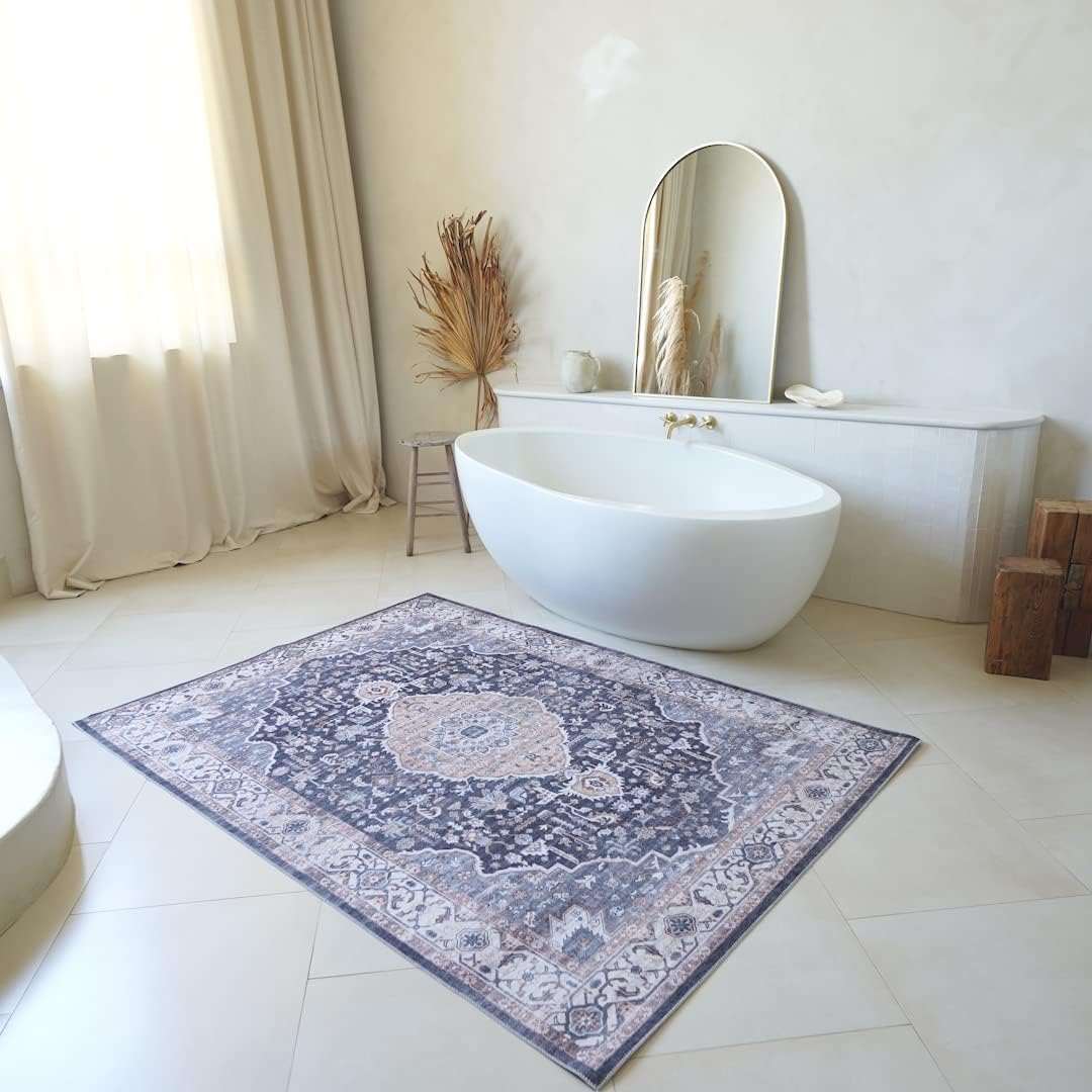 Elegant bathroom with patterned rug and tub.