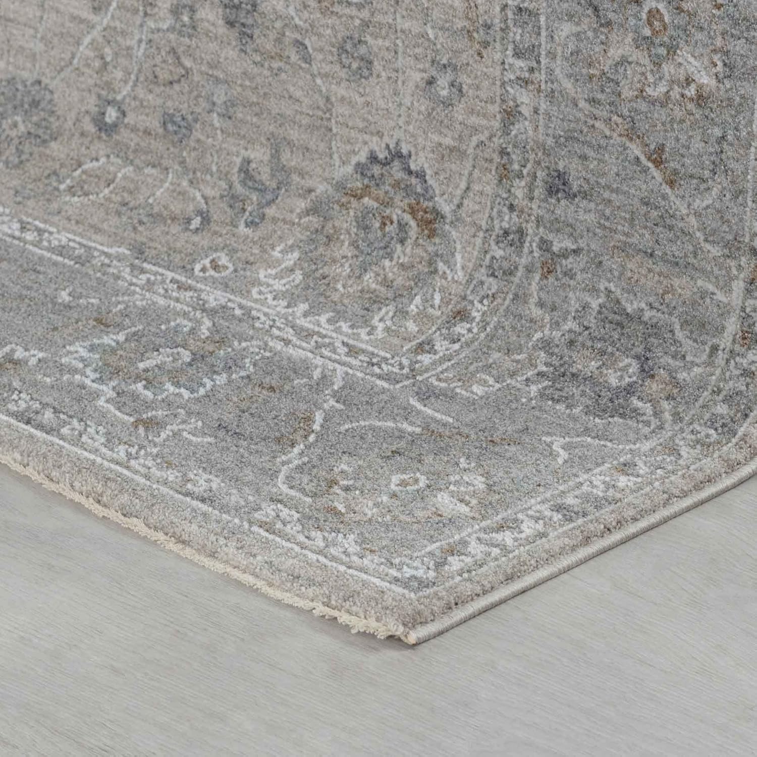 Gray decorative carpet on light wood floor.