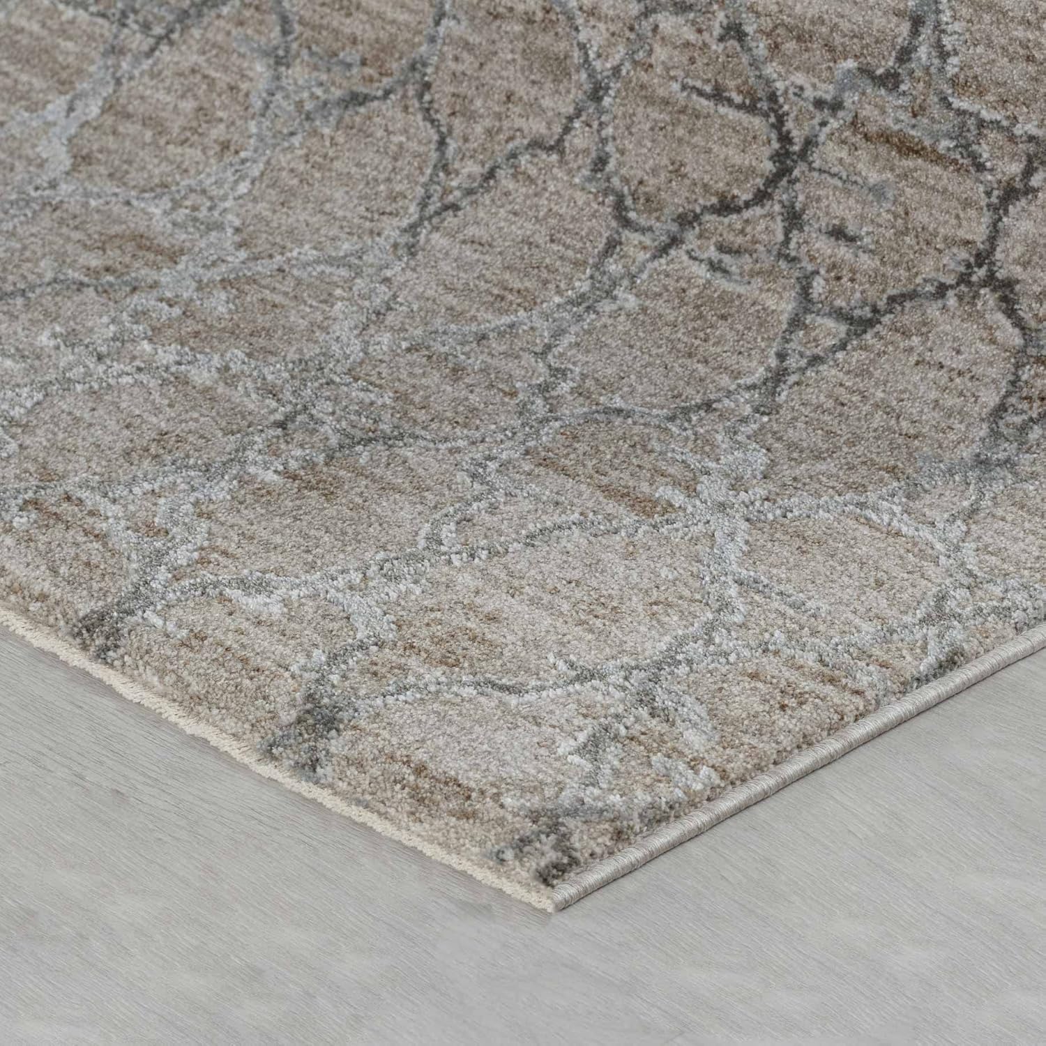 Gray patterned rug on wooden floor