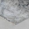 Gray abstract patterned rug on wooden floor