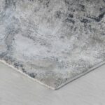 Gray abstract patterned rug on wooden floor