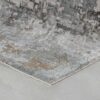 Abstract-patterned area rug with gray and blue tones.