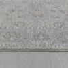 Gray patterned rug on wooden floor